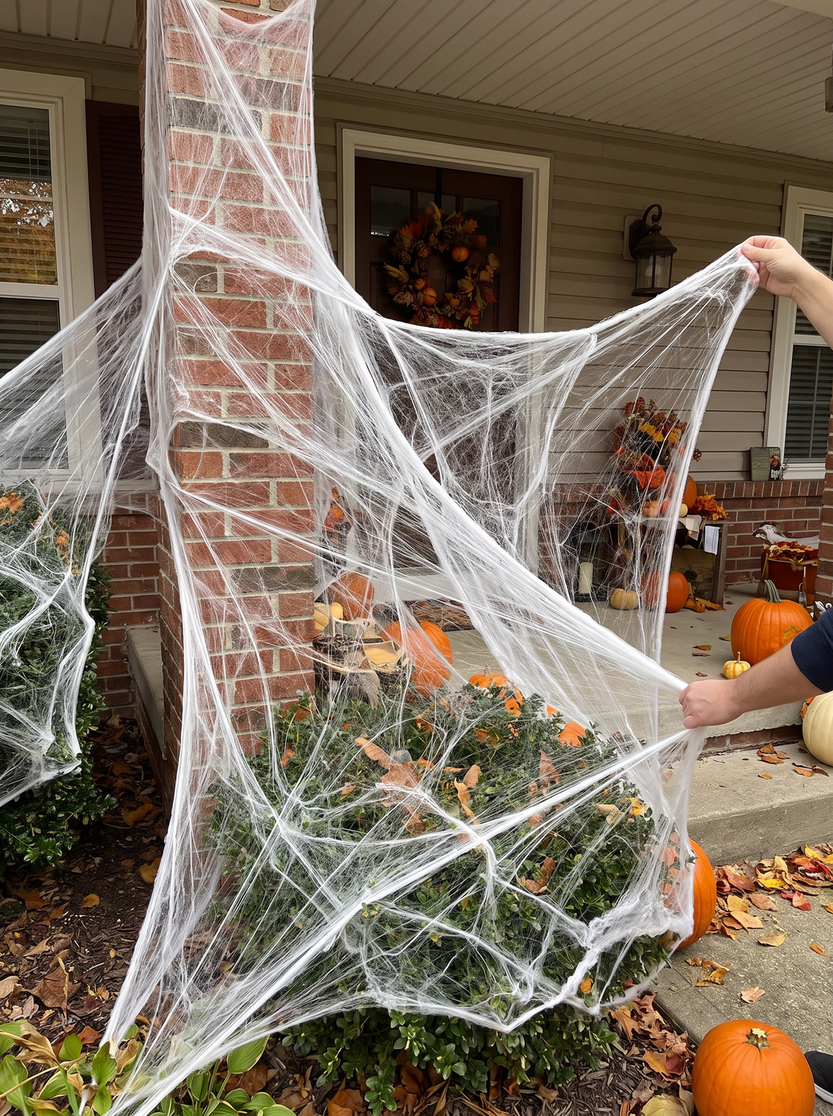 Outdoor spider web decoration across a house front